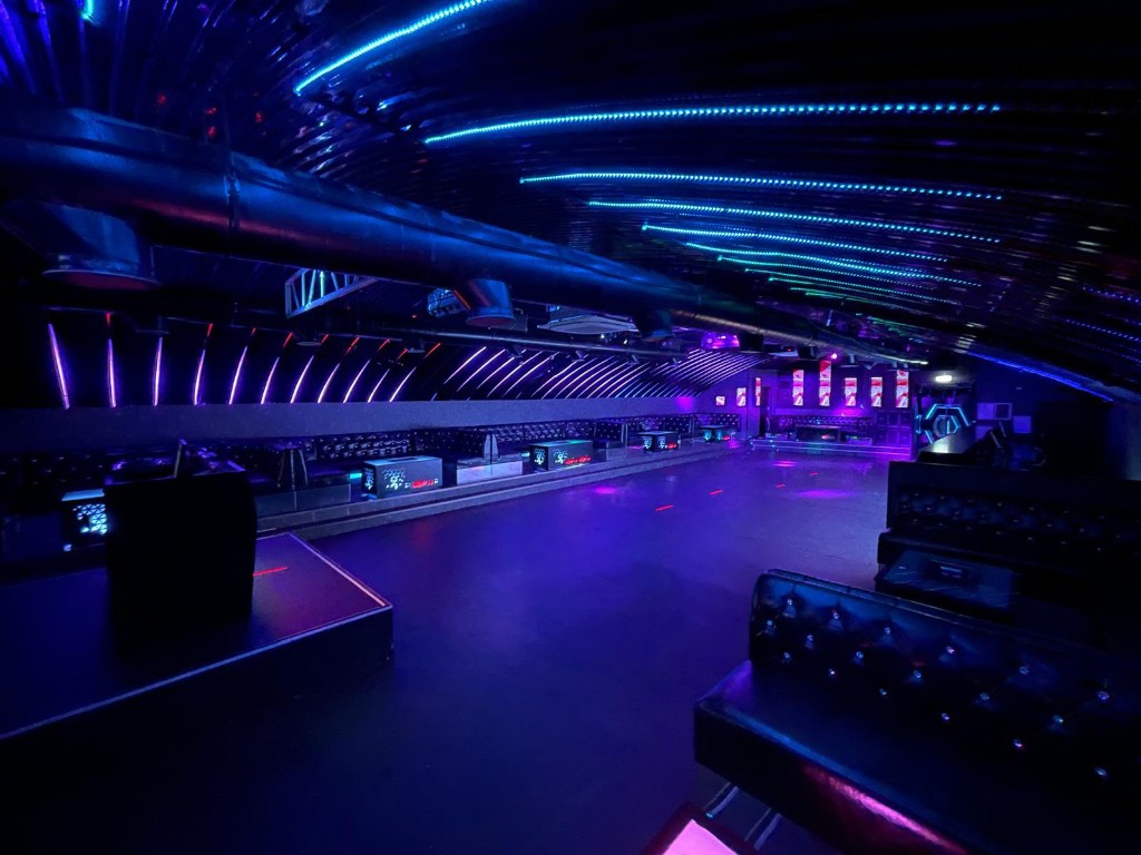 DJ set with pink lasers and LED backdrop