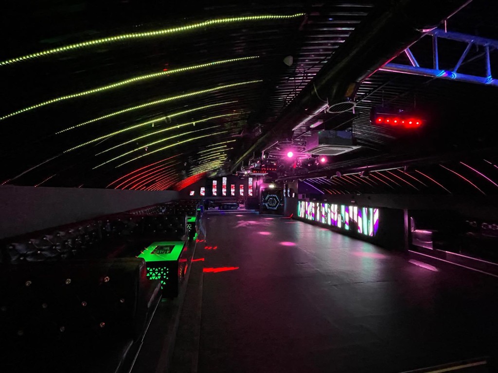 VIP leather booths under blue LED ceiling